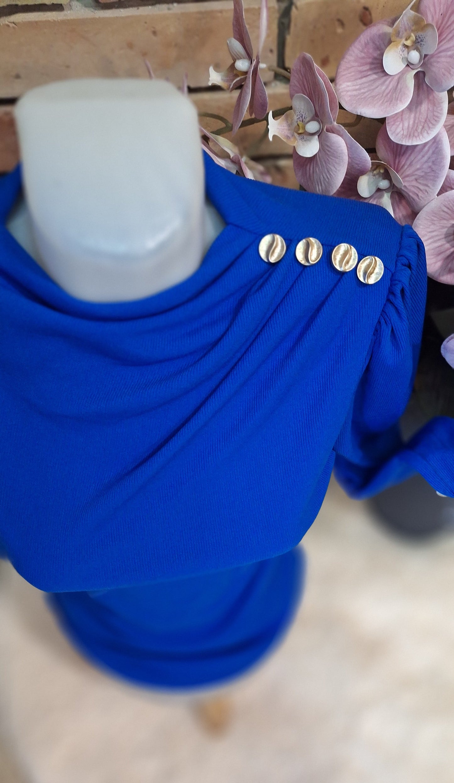 Bordázott gombos felső